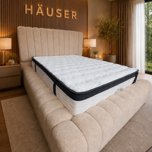 Beige boucle Panello Ambassador bed with panelled headboard and deep channel footboard by Hauser Interiors